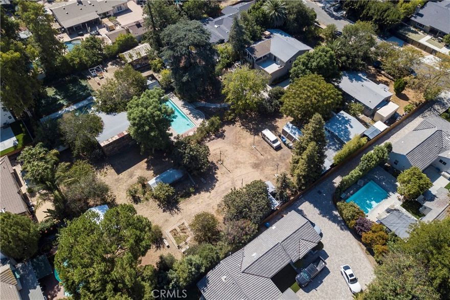 Fantastic Development Opportunity! Rare offering-flat, gated 1/2 acre parcel with agricultural zoning and endless potential. This property sits adjacent to another 1/2 acre parcel also for sale (5828 Calvin Avenue), giving buyers the option to combine both for a full acre of prime land.. Existing home is a tear-down making this a true land value opportunity to design and build your dream estate, complete with ADU, guest house, or multiple structures. A perfect opportunity for developers, investors, or those seeking an expansive, private compound. This property has 2 legal address' (5832 and 5834). Buyer to cooperate with 1031 tax exchange. Photos show both parcels together.