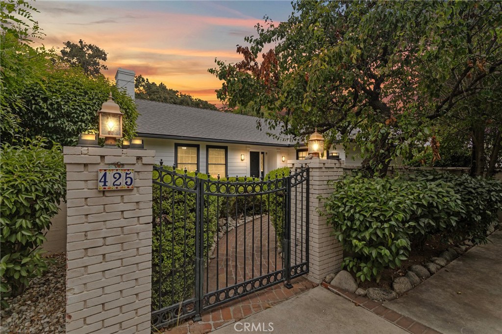 Welcome to this charming single-story ranch-style home situated on an oversized 18,600 sq ft lot, offering room to grow, entertain, garden, or simply relax. This residence features a newly renovated kitchen, new roof, fresh interior and exterior paint. Inside, you'll find a spacious living room, a formal dining room with floor to ceiling windows that overlook the backyard, gorgeous wood-trim windows that let natural light pour into every room, and a dual fireplace for cozy evenings. Beautiful original details including built-ins, a vintage entry chandelier, hardwood floors, swinging doors into the kitchen and den, and vanities. Additional features include a long driveway with plenty of parking ideal for a boat, RV, or extra vehicles. Located just minutes from Claremont Village, The Webb Schools a private boarding/day school 9-12, Claremont Colleges, parks, trails, and top-rated schools. This home is perfect for families or buyers seeking character, charm, nature, and convenience in a beautifully established neighborhood. Homes like this rarely hit the market you really have to see it in person to appreciate all the thoughtful details.
