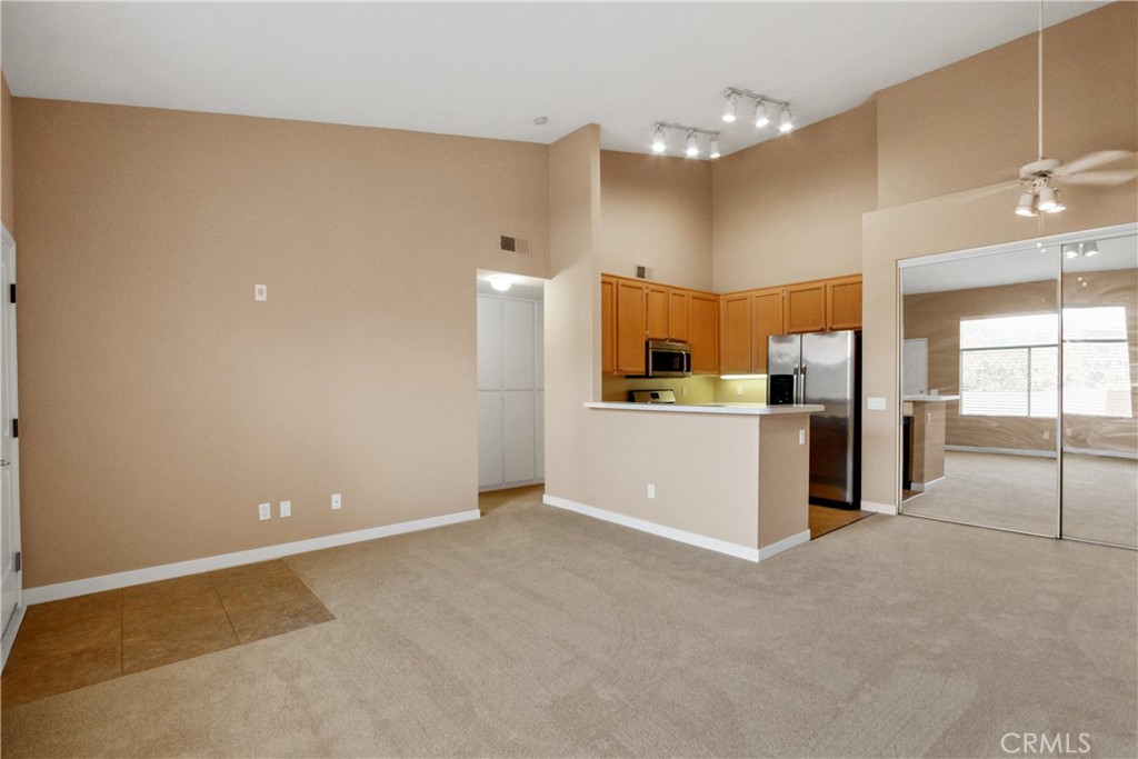 Welcome to this lovely upper-level unit in the highly sought-after gated community of Tuscany, nestled in the heart of Foothill Ranch. This spacious 1-bedroom, 1-bathroom condo features an open floor plan with soaring vaulted ceilings, fresh neutral paint, and plush newer carpet throughout. The generous master bedroom boasts a large walk-in closet and ample storage space, while the bathroom offers double sinks and a shower/tub combo for added convenience. The kitchen is beautifully appointed with stainless steel appliances, including a gas range—perfect for cooking enthusiasts. Enjoy the ease of a full-size washer and dryer, discreetly tucked into the laundry closet on your private front patio. Residents of Tuscany enjoy access to top-tier amenities including two sparkling swimming pools, a relaxing spa, tennis courts, a clubhouse, fitness center, playground, outdoor cooking area, and even a putting green! Ideally located near top-rated schools, shopping centers, dining options, and with easy access to toll roads and freeways—this condo offers both comfort and convenience in one perfect package. Don’t miss your chance to live in one of Foothill Ranch’s most desirable communities!