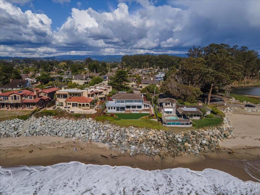 Welcome to 22780 E Cliff Dr., an oceanfront oasis with endless potential on an iconic stretch of coastline! Wake up to the sound of waves and panoramic ocean views from every bedroom in this rare coastal gem. Sited on a sprawling 32,801 sqft lot, this 3,394 sqft oceanfront home offers tremendous privacy, solid craftsmanship, and endless potential to create your dream retreat. With the Pacific as your backyard, you'll never tire of nature's endless beauty.   Thoughtfully built and well-maintained, the home features strong bones and a timeless layout, awaiting your personal touch or modern updates. The oversized detached garage includes a spacious workshop ideal for hobbyists, storage, or a potential ADU conversion. With abundant off-street parking and room to grow, the property is perfect for those seeking a full-time residence or a coastal getaway home.  Whether you're savoring sunsets from the deck, entertaining with the ocean as your backdrop, or exploring the potential for expansion, this is coastal living at its finest. Properties like this don't come along often...seize this rare opportunity to make it yours!