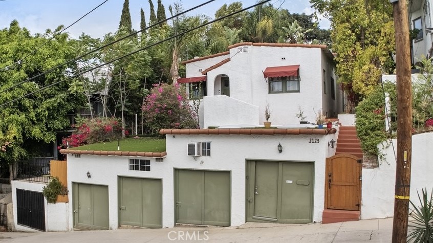 Set above the street behind lush landscaping, this beautifully renovated 4 bed, 3 bath home in Echo Park blends modern luxury with classic charm and sits on a massive 7,500 sqft lot. The recently added primary suite is luxurious with tall ceilings, abundant natural light, a large closet, and an en-suite bathroom that feels like it is straight out of a resort. The updated kitchen is well appointed with plenty of cabinet space and concrete counters, while two spacious secondary bedrooms share a renovated full bath. Step outside to a large backyard oasis featuring a jacuzzi, firepit, outdoor kitchen, and a detached two-level bonus studio offers incredible flexibility for a home office, creative studio, or gym. Facing the street, three of the four garage bays have been converted into a guest house with its own bath and kitchenette, while the fourth bay remains as storage. Enjoy the thoughtful upgrades like a built-in sound system, alarm system, central HVAC, hallway W/D hookups, the tankless water heater. A truly unique turnkey home in one of the city's most vibrant neighborhoods!