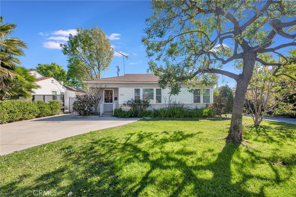 This beautifully updated, 3 bed, 2 bath, 1372 sq ft, 1940s bungalow with detached 2 bed, 1 bath, 710 sq ft Guesthouse/ADU (without permits), & separate 2-car garage, sits in a quiet residential neighborhood in the heart of Valley Glen. Lots of possibilities! Blending vintage appeal & modern convenience, the house boasts a newer AC, raised foundation, hardwood floors, decorative wood siding, & covered front porch, while a wide driveway with an RV/car gate provides access to the detached 2-car garage. Enter directly into a spacious, light-filled living room with a large picture window. A graceful archway connects the living & dining area seamlessly. The kitchen boasts a sleek, black & white aesthetic with recessed lighting, tile floors, white cabinets, a white tile backsplash, black granite counters, black appliances, & back door leading to the yard. Down the hall is a freshly updated ¾ bath with new counter, mirror & shower enclosure & an extra-large laundry room for added utility & storage. Two good-sized bedrooms share the hall bath while a sizable primary suite has brand new carpet, as well as dual walk-in closets, a glass slider to the yard, & an en-suite bath with new flooring, mirror, light fixture, counter, & faucet. Storage abounds throughout the house with closets, linen cabinets, a pantry, & the garage, making the most of the space! The spacious backyard includes several patio areas, walkways, a lawn, a mature shade tree, & abundant fruit trees allowing you to take advantage of fresh produce, better than a farmer’s market, just out your back door. A detached guest house adds versatility with an open-concept great room combining kitchen, dining, & living areas. The two guesthouse bedrooms both have mirrored closets & ceiling fans & share access to a full hall bath. The guest house has its own heater, AC, water heater, & storage shed, making it a perfect space as an ADU or casita, studio space, a home office, gym, or really, whatever you can imagine. A detached 2-car garage provides space for parking & storage. Take advantage of the R2 zoning in the area to further develop the property, utilize the existing guest house, or convert the detached garage to an additional ADU space, all to add additional means of income to the property. The home is well situated near to shopping, dining, entertainment, recreation, & major transportation routes. Don’t miss the opportunity to tailor the space to suit your needs & make this your new home!