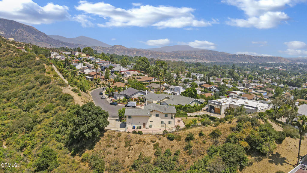 A spacious 4-bedroom home in a gated cul-de-sac, just moments from Angeles National Forest, with room to grow and views you'll never want to leave.________________________________________Welcome to a rare opportunity at the top of the hill--where the breeze is cooler, the views stretch across Sylmar's natural canyons, and the privacy is unmatched. Tucked away on a gated cul-de-sac just minutes from May Canyon and the Angeles National Forest, this 4-bedroom, 3-bath home is your chance to embrace a peaceful lifestyle surrounded by nature while still enjoying great freeway access, local parks, and nearby golfing.With approximately 2,900 square feet of living space and set on an expansive 29,000-square-foot lot, the home features a layout that's both comfortable and functional. The formal entry welcomes you into a combined living and dining room--ideal for quiet evenings or large gatherings. Just beyond, the kitchen offers generous counter space, extensive cabinetry, a center island, and seamless flow into a sprawling great room. This open-concept area includes space for a dining table, entertainment nook, and a cozy sitting area--perfect for hosting family and friends. Glass sliders connect you directly to the spacious backyard, inviting indoor-outdoor living.Throughout the home, gleaming hardwood and tile floors reflect the care that's been invested over the years. The well-sized bedrooms include two with private balconies overlooking the hills, and a wonderfully spacious primary suite with walk-in closet, dual sinks, ample counter space, and a skylit jetted tub for soaking under the stars.The home is in very good condition and offers a clean canvas for your personal updates--whether modernizing the interiors or enhancing the outdoor areas. The oversized lot offers room to expand the home or add an ADU (Accessory Dwelling Unit), and the spacious driveway and two-car garage provide gated parking plus room for guests.Whether you're drawn by the scenic beauty, the generous living space, or the proximity to nature, this Sylmar retreat offers a lifestyle you'll be proud to call home. Come explore the possibilities.Key Features:4 bedrooms, 3 bathroomsApproximately 2,900 sq ft on nearly 29,000 sq ft lotLocated on private gated cul-de-sac near Angeles National ForestGreat freeway access and proximity to parks and local golfRoom to expand or add ADUViews of local hills, private balconies, spacious layout