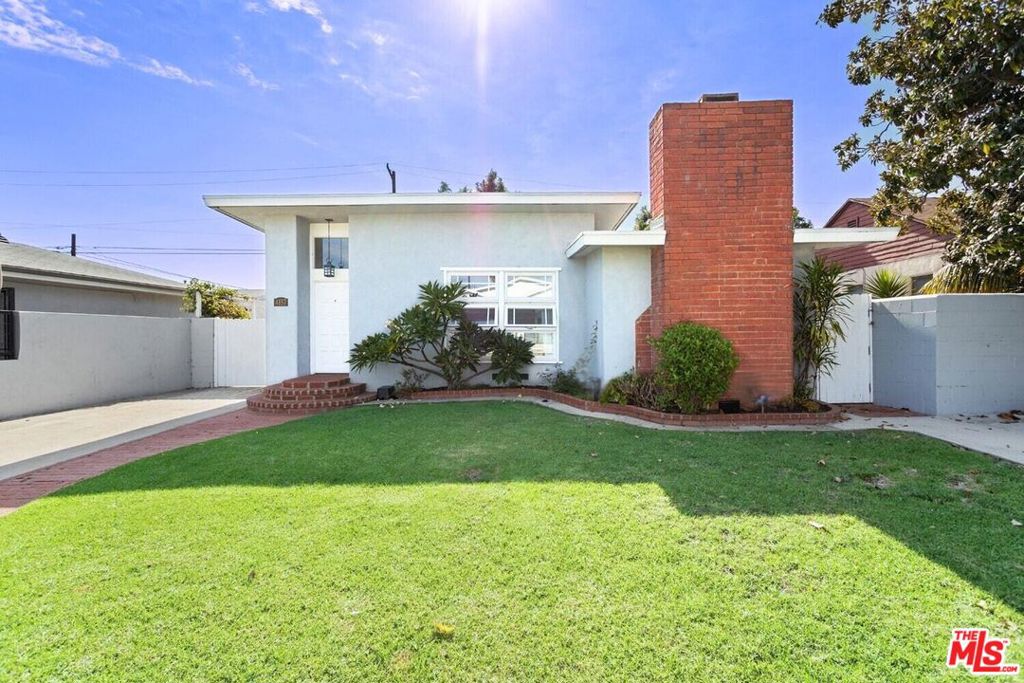 A quintessential California beach bungalow in Marina del Rey, one of the Westside's most coveted neighborhoods. Light pours through oversized windows into every room, highlighting the home's warm wood floors and airy layout. The three-bedroom floor plan includes a bright and spacious primary suite that opens directly to the lush backyard through sliding glass doors, offering seamless indoor-outdoor living. The kitchen updated with high-end appliances and a commercial-grade range offers everything needed for inspired at-home cooking, while a graceful hallway arch and brick fireplace hints at the home's original mid-century character. Outside, low-maintenance landscaping surrounds the home, creating a green oasis that feels peaceful and private. Under a mile from the Marina waterfront and just minutes to neighborhood parks and standout restaurants, this home strikes the perfect balance of cool, character-filled interiors and easy coastal living. Calling all investors and developers too: a rare opportunity to buy and hold, add an ADU, or expand the existing footprint.