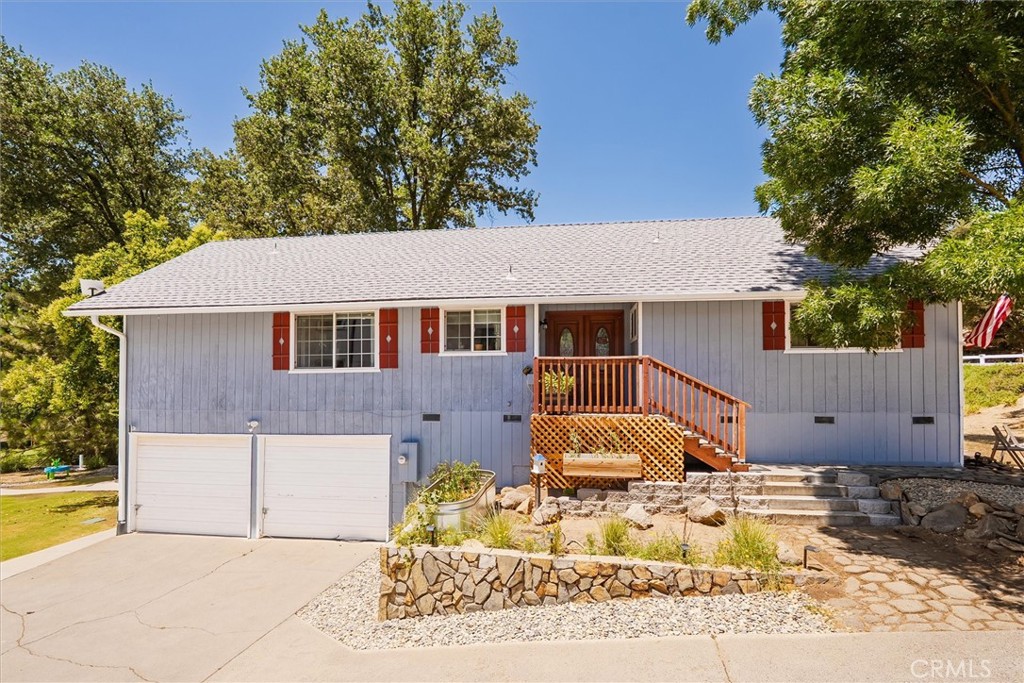 A beautifully maintained and truly move-in ready home in the desirable Goldside neighborhood, backing to the community golf course! This charming property offers comfort, care, and thoughtful updates throughout. The shady Bermuda grass lawn is lush and green thanks to a full sprinkler system, and the backyard feels like an oasis in the evening with dappled light and peaceful golf course views. Step inside to find engineered laminate flooring in the main living areas, with a spacious layout that includes 3 bedrooms and 2 bathrooms. The cozy living room features a free-standing wood stove with tile surround, recessed lighting, and a sliding glass door that opens to a wood deck, ideal for dining or relaxing outdoors. The HVAC system and roof were both replaced in 2017. Sellers also added new fencing for privacy and comfort. There’s ample storage throughout the home, and the oversized attached 4-car garage offers plenty of space for vehicles, tools, or hobbies. Community water and sewer add convenience and peace of mind...no need to worry about a well or septic system. This home is full of warmth and care, inside and out. Call your local Realtor today to schedule a showing!