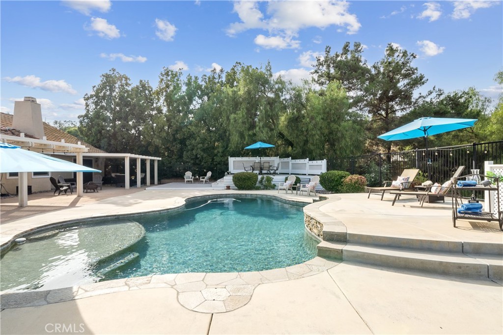 Located in the heart of Temecula Wine Country, this private, gated single-story estate offers 4 bedrooms, 3 bathrooms, and over 3,200 sq. ft. of living space on an expansive 87,991 sq. ft. lot—ideal for a future ADU. Interior highlights include wood and stone flooring, crown molding, and a stacked-stone fireplace. The gourmet kitchen features granite counters, stainless steel appliances, and a center island that opens to the family room and breakfast nook. A formal living room with balcony access provides an inviting space for entertaining or enjoying morning views of hot air balloons. There are two fireplaces: one in the living room and one in the primary suite, uniquely positioned between the bedroom and bathtub—creating the perfect ambiance while soaking in the tub. The primary suite also offers a bath, walk-in closet, and patio access. Secondary bedrooms are generously sized, with two sharing a Jack-and-Jill bathroom. A versatile bonus room provides the ideal space for a home office, gym, or playroom. The backyard is designed for resort-style living with a sparkling pool, full-length covered patio, and elevated sun deck with panoramic views. The property also includes fruit trees, RV parking, western-style outbuildings, and fully paid-for solar panels for energy efficiency and cost savings.
All just minutes from award-winning wineries, Lake Skinner, shopping, and top-rated schools.