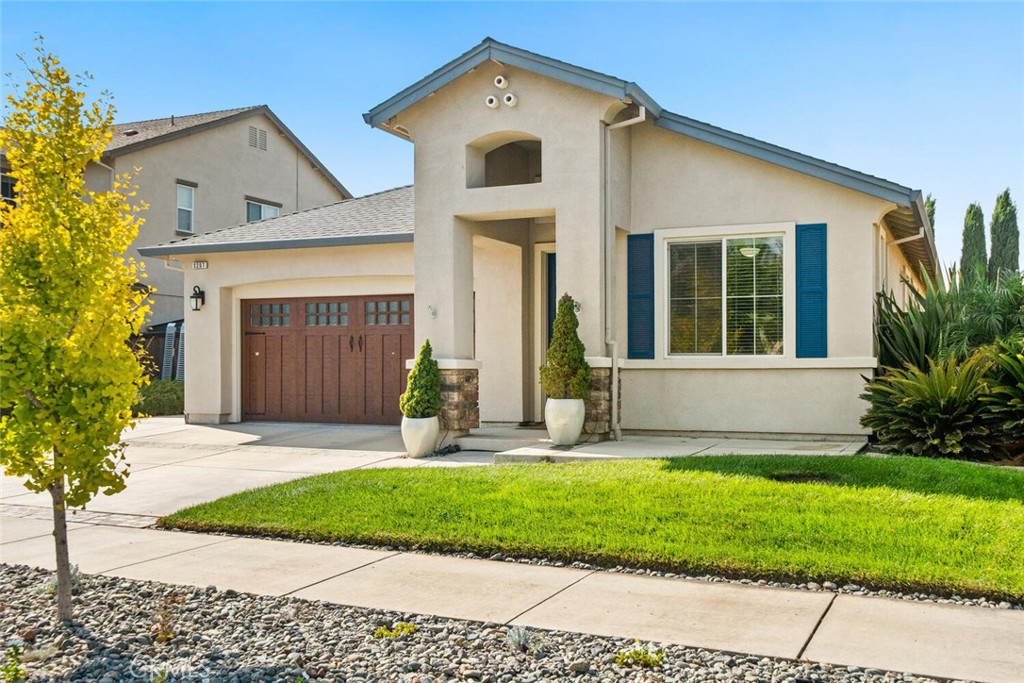 This newer North Chico home is move-in ready and offers great curb appeal with a custom wood-look garage door, a charming blue front door, and mature landscaping. The extra-wide driveway and side double-gates provide ample parking options, including potential for RV, smaller boat, or trailer storage. Inside, you'll find LVP plank flooring and an open floor plan that feels light and bright, thanks to high ceilings and numerous windows. The kitchen features an island, granite countertops, stainless steel appliances—including a new dishwasher and a 5-burner gas range with grill and dual ovens. A custom wall mural inspired by the Ahwahnee Hotel in Yosemite and warm wainscot paneling add a cozy, inviting touch. The home has four bedrooms: the primary and two others are adjacent, while the front bedroom with a built-in Murphy bed makes a versatile office or guest room with privacy. The backyard is truly delightful, offering a lush green lawn, covered patio with lighting and fan, a firepit area, accent lighting at night and two usable side yards. One side yard includes a vegetable garden with raised beds and a new Trex-style deck walkway, while the other provides concrete space perfect for an RV or kids’ play area. 16 solar panels installed in 2021 for low energy costs. This well-loved home is ready for its new owners—and it’s sure to be a place you'll love too!