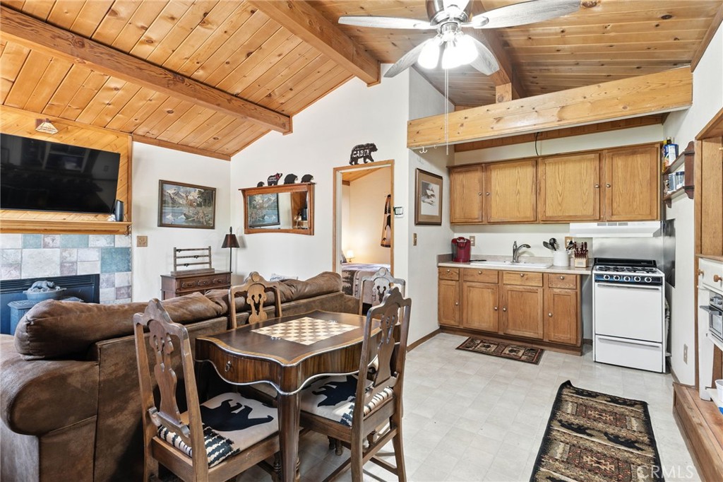 Cozy, turnkey mountain retreat in Sugarloaf, just 20 minutes from Big Bear Village. This 1-bedroom, 1-bath home is set behind a gated entry with a spacious driveway, fenced yard, and two mature trees that provide shade and privacy. A storage shed in the back offers extra space for tools or hobbies. This property holds a valid short-term rental permit, making it an ideal investment opportunity as well as a perfect weekend retreat.
Inside, the living room features a bay window, cathedral ceiling, and a wood-burning stove for a warm, inviting feel. The efficient kitchen includes oak cabinets and additional storage for pantry use or small appliances. The bedroom is tucked away at the rear with an ensuite bath and a stacked washer and dryer.