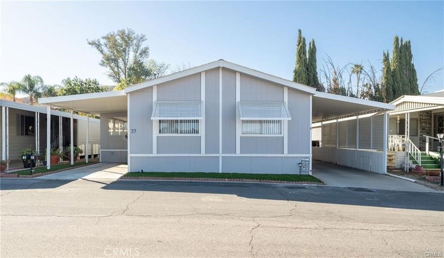 This is a beautifully upgraded two bedroom home with an enclosed lanai area to add extra living space or entertaining space on the left side of the home.  This lot has two carports and an extended driveway with a detached shed and located in the back of the park with no rear neighbors!  Visitor parking is right across the road and it's just a quick walk to the clubhouse and pool area to enjoy the amenities that Hillside Mobile Estates has to offer!  Besides having lovely curb appeal, this gorgeous home has LVP floor installed just 3 years ago, painted 3 years ago, newer ceiling fans throughout, and an upgraded and spacious kitchen that includes a pantry and granite countertops!  The guest bathroom has an upgraded vanity and primary bedroom is huge with connected en-suite bathroom.  The space rent is low for this unit and also includes trash and water for convenience and affordability!  Don't miss out on this beautiful home!