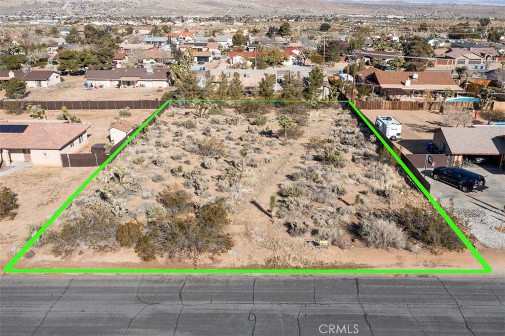 This beautiful homesite is ready for your dream home. Located in the desirable Sky Harbor neighborhood, it's surrounded by well kept yards and homes. It is ready for your build. Shopping and restaurants are nearby, yet this property located sits in a quiet neighborhood just south of Yucca Valley's landmark Burnt Mountain (Once a hangout spot for the Rat Pack). Flat and buildable with easy availability of water and power. Minutes from Joshua Tree National park, the JT village, Old Town Yucca and just a bit further to the newly revived and energized downtown 29 Palms.