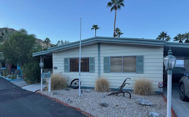 PRICE DRASTICALLY REDUCED TO SELL QUICKLY AT $129,750! SELLER VERY MOTIVATED! Panoramic mountain views at a great low price. Rent-controlled leased land. Not Indian Land. Step into comfort and convenience with this spacious double-wide manufactured home in a welcoming 55+ community. This charming home is perfect for enjoying a relaxed lifestyle in a prime location on a peaceful cul-de-sac. It is designed for easy living with two generously sized bedrooms and two bathrooms, an open-concept living and kitchen area, granite countertops, beautiful custom-tiled flooring in the kitchen and hallway, and carpet in the living room and bedrooms. The 2022 HVAC system is just one of the upgrades to this home; it also includes an evaporative cooler. Located in a vibrant community with a range of amenities and social opportunities, you'll love the lifestyle this home offers in Palm Springs. LOW LOT RENT. Don't miss out on this gem --your new home awaits!
