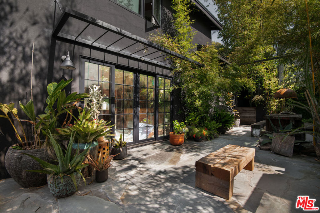823 is a creative oasis in Venice's coveted Golden Triangle. It's conveniently located close to Venice Pier, the Marina, Abbot Kinney, and many of LA's best restaurants and culture. Upon arrival, you'll be greeted by its impressive gates which warmly welcome you to its Balinese-inspired front gardens. The tri-level home has been completely remodeled, featuring concrete floors, vaulted ceilings, massive wood beams, and abundant natural light. The main level's open floor plan is the perfect space to hang out with family or entertain a large group of friends. The nearby cook's kitchen has everything you'll need to whip up an amazing meal that can be eaten at the bar or large dining area. The backyard is equally stunning (renovated in 2021), acting as a Bohemian retreat and an extension of the home's living space. Sit by the large, rustic (gas) fireplace, or grill out in the dining area surrounded by mature bamboo gardens. An artist's studio with sliding French doors opens to the area and can be used for all of your personal or family projects,; it also nicely converts to an entertaining space. Each of the three bedrooms has an adjacent bathroom with plenty of closet storage space and natural light. The property also has a two-car garage, an outdoor shower, a new roof (2024), all new windows (2021) skylights throughout, and a halfpipe (yes!). It is fully walled and gated and has many unique design details and artistic accents.