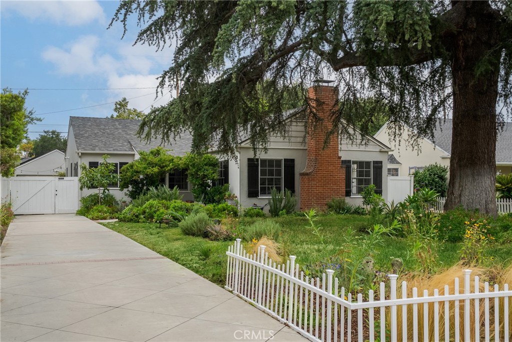 Welcome to 2014 N Flower St., a beautifully preserved Traditional Ranch-style home with charming Cape Cod influences, nestled in the heart of Santa Ana’s historic district. This 3-bedroom, 2-bath residence offers 1,729 square feet of living space, blending timeless character with thoughtful modern updates—including the significant property tax savings of the Mills Act and solar panels.
Inside, you’ll enjoy an appealing blend of historic charm and contemporary comfort. The living room features a cozy gas fireplace, elegant crown molding, and built-in bookcases, all framed by large mullioned windows that fill the space with warm morning light. Original hardwood floors flow throughout the main living areas, complemented by updated electrical and plumbing systems for peace of mind. A practical California basement provides valuable storage and houses utilities.
Outside, the in-ground pool and spa offer a private oasis perfect for relaxing or entertaining, while a majestic Deodar Evergreen graces the front yard, adding shade and curb appeal.
Car enthusiasts will appreciate the fully renovated garage, complete with custom cabinetry, epoxy flooring, and plenty of room for projects, storage, or vehicle care.
Set on a picturesque, tree-lined street just minutes from downtown Santa Ana’s vibrant shops, restaurants, and cultural attractions—and only a short drive to the charming boutiques and dining of Old Towne Orange—this home is a rare find. It’s the perfect blend of classic style, modern upgrades, and energy-efficient features. Come check it out!
