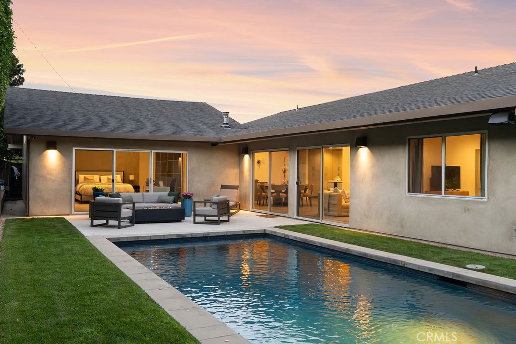 Nestled on a coveted cul-de-sac in one of Newport Beach's most desirable neighborhoods, this exceptional home offers an extraordinary living experience. Designed and reimagined by renowned architect Carlton Graham, the property balances modern sophistication with timeless appeal. Vaulted ceilings with recessed lighting create an open, airy atmosphere, complemented by wide-plank flooring throughout the interior. Large windows and glass sliders flood the space with natural light, seamlessly connecting the interior to the outdoor beauty. The living and dining areas flow effortlessly, with a cozy fireplace adding warmth and ambiance. The gourmet kitchen boasts high-end stainless steel appliances, abundant cabinetry, ample countertops, a striking waterfall island, and built-in seating—ideal for casual dining or entertaining. The primary suite offers a serene retreat with expansive proportions and a private view of the backyard. It also features a spacious walk-in closet and a luxurious ensuite with a spa-like bath. Outside, unwind in your private backyard oasis, complete with a pool and soothing waterfall, surrounded by lush greenery for ultimate privacy. Whether dining alfresco or lounging by the pool, this outdoor space is the perfect retreat. Additional highlights include an attached 2-car garage and a newly integrated sound system. Enjoy close proximity to the Back Bay, beaches, shopping, dining, and top-rated schools. Don't miss your chance to see it in person. Contact us for a tour today.
