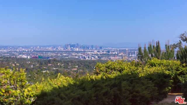 979. Bel Air's newest development opportunity. Through the internationally renowned and prestigious Bel Air gates, and located on a prime stretch of Bel Air Road, this grand estate site is surrounded by some of the most significant trophy properties in the area. Approx one acre flat, gated and private with city views, this property is offered fully-permitted with RTI plans and ready to build a palatial Richard Landry-designed French manor that can be finished either traditional or more contemporary. The approximately 24,000-square-foot estate which includes 4,000 sf of sub parking for 7 cars, will feature a dramatic gated motor court entry, two luxurious levels of impeccably designed living space plus a spectacular lower level with theater, fitness center, recreation lounge, spa and salon. This offering presents an opportunity to build a world class trophy estate with both land and views or there is also the option to fully renovate and reimagine the existing 11,600 SF property.