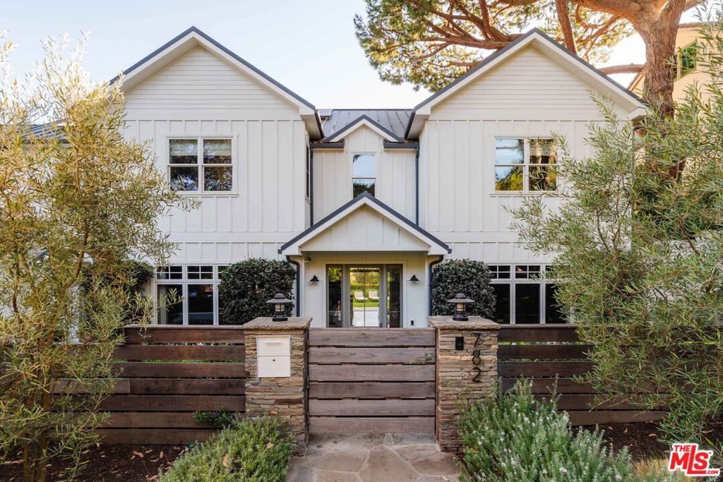 Welcome to one of Rustic Canyon's most beautiful homes to grace the market in recent years. This modern farmhouse blends artisanal details, top fixtures/finishes, voluminous rooms, and an open concept/indoor-outdoor layout to achieve exalted and unparalleled design. Guests are welcomed by double-height ceilings and wide-plank white oak floors leading to the heart of the home: a large open concept living room that pours out to the private backyard through large Fleetwood sliding doors - all underneath gorgeous wood-beamed ceilings. Main level highlights include a top-of-the-line kitchen with island, Sub-Zero and Wolf appliances, a large walk-in pantry, a butler' pantry with wine fridge leading to a gorgeous formal dining room, an office, and mud room with secondary laundry. Four bedrooms grace the upstairs featuring the large primary suite with two walk-in closets and large bathroom with oversized steam shower, separate tub, and sophisticated heated stone floors. Down the hall past the laundry room is a den through a secret bookshelf door, perfect for entertaining friends and little ones, which also leads down to the main level with a 2nd staircase. The lower level features a gym and a large state-of-the-art media room with bar, screen/projector, and a secret passageway to the utility rooms and a rear stairwell to the backyard. The backyard features a built-in BBQ, al fresco dining, a mature oak tree, a large spa with waterfall, and a firepit - all privately hedged with views out to the canyon. The home is completed by a two-car garage with EV charging. With a southeastern exposure and set in a prime part of the canyon, the property enjoys rare bountiful sunlight and close proximity to Rustic Canyon Park, Canyon School and The Palisades Village. Built in 2012 by Core Development Group, the residence has been further updated since. This is a rare offering not to be missed.