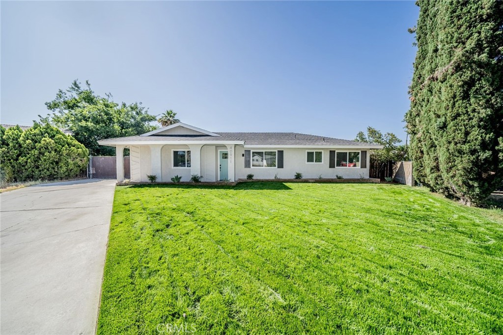 **5 CAR DETACHED GARAGE**RV PARKING**HUGE LOT** This one checks all the boxes! Welcome home to 40911 Lela May. Newly RENOVATED and just waiting for you to call home! Inviting curb appeal greets you with freshly painted exterior and attractive landscape touches. Stepping inside you will enjoy a spacious living room with stone fireplace and large windows bringing in lots of natural light. From there step inside your revitalized kitchen with NEW countertops, backsplash, cabinetry, large center island with breakfast bar, and all NEW appliances. Adjoining the kitchen you will find your laundry room and primary bedroom suite with ensuite bathroom featuring large walk in shower and NEW dual vanities. Down the hallway you will enjoy 3 more bedrooms all featuring NEW carpet and NEW ceiling fan/light fixtures. There is also a secondary bathroom that has been upgraded and features tub/shower combo. Home also features a large 5th bedroom/bonus room that can serve many purposes. (Note tax records show 4 beds but there are 5 rooms all with closets and doors) Additional upgrades throughout the home include NEW vinyl plank flooring throughout the living areas and kitchen, NEW interior and exterior paint and NEW lighting fixtures and hardware. Step outside and you will find the BEST part of all! Your outdoor space is an amazing 15,682 sq ft fully fenced with rarely available huge detached 5 CAR GARAGE! Possibilities to utilize this for parking/storage/work shop/conversion to ADU and more! Garage sits back behind the home offering privacy and large side yard access perfect for RV/BOAT parking and there is still plenty of grassy backyard space available to relax, entertain, and customize however you prefer. This tastefully modernized home is MOVE IN READY. Great location close to shopping, schools, and dining. No HOA adds to the homes value. You don't want to miss this one!