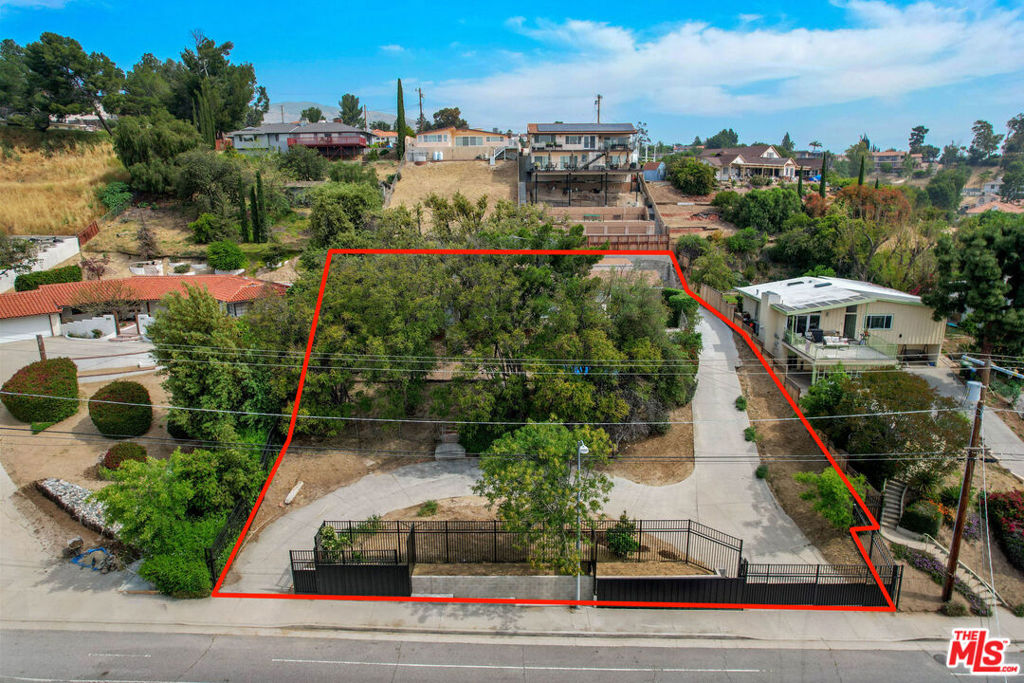 Heavy Fixer/Exceptional Development or Renovation Opportunity in Prime Granada Hills! Ideal for Cash or Hard Money Buyers Only. Set on an expansive flag lot tucked away from the street, this double-gated property presents a rare opportunity to reimagine or rebuild in one of Granada Hills' most desirable neighborhoods. A circular driveway and mature landscaping provide a peaceful, private atmosphere, while the generous lot size offers ample space to design a custom home with the potential to add 1-2 ADU's (buyer to verify local regulations). Located just minutes from top-rated public and private schools, scenic parks, hiking trails, and with easy access to the 118 and 405 Freeways, this property combines convenience with endless potential. A true hidden gem for an end-user looking to create their dream oasis or a savvy investor seeking a promising project. BLIND OFFERS WILL NOT BE RESPONDED TO.