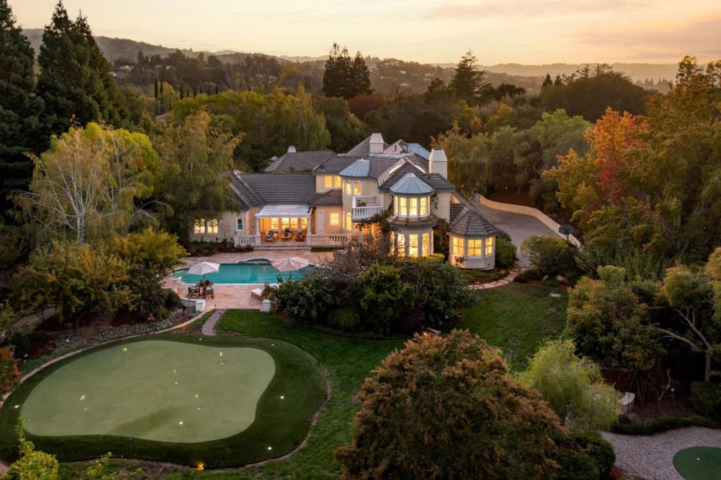 This quintessential Los Altos Hills estate offers splendor on more than 1.1 acres with a coveted privacy of a cul-de-sac. This luxurious French country design is set amid a backdrop of lush foliage, resort-inspired amenities and balcony views. Featuring soaring ceilings, designer light fixtures and rich millwork this almost 5500 square foot home is an ideal blend of timeless elegance and modern amenities. Natural light permeates the home with French doors at every turn leading to a central courtyard, a perfect venue for outdoor entertaining. The flowing floor plan offers formal rooms, a family room, a media room, an executive office, and 5 en suite bedrooms. Outside, stunning grounds feature a trellised lounge, sparkling pool and spa, putting greens for golf enthusiasts, a batting cage and tranquil meditation nooks. Moments away from the area's best trail heads, country clubs and main commute routes with access to acclaimed Palo Alto schools (buyer to verify enrollment). Welcome home!