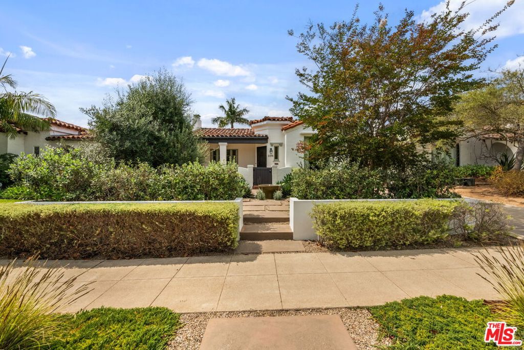 Spanish stunner with 3 bedrooms and 2 baths effortlessly combines authentic character with sophisticated, chic updates. The beautifully landscaped front yard, featuring mature native plants and a majestic olive tree, is centered around a tranquil fountain that leads to a spacious stone-tiled covered porch and inviting entry. Lush greenery surrounds this property, complemented by a custom-built wall and gate, creating a serene and private Zen-like retreat.Inside, the airy living room boasts a dramatic beamed barrel ceiling, picture window, art niche, and tiled fireplace. The front-facing formal dining room, with 6-foot picture window overlooking the original tray ceiling, opens to a sun-filled breakfast nook and an updated kitchen with a large skylight, Ann Sacks countertops and backsplash, stainless steel appliances, including gas/range oven and convenient laundry area with side door that leads to driveway and backyard. The home offers three generously sized bedrooms. The spacious primary suite features a custom closet and French doors that open to the backyard oasis fully enclosed by mature hedging for ultimate privacy. The backyard features a turf landscaped yard, ample hardscape for entertaining, an oversized painted brick patio and a detached garage with finished walls, recessed lighting and mini-split unit Ac/heat, ideal for playroom/home office/gym.The second bedroom includes an ensuite updated 3/4 updated bath and shower with subway tile finishes. A remodeled full bathroom in the hallway features a separate bath and shower and dual basins. The third bedroom showcases a period coved ceiling and cedar-lined closet, adding to the home's timeless appeal.Additional features include original oak floors, central AC/heat, updated HVAC system, wired alarm, arched doorways, and recessed lighting. Located near Century City, UCLA, and Beverly Hills, and in the Westwood Charter School district, this home is move-in ready.