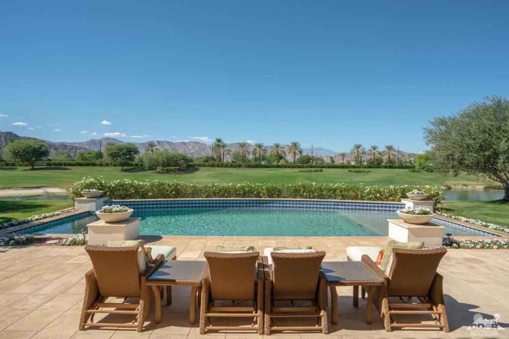 Welcome to your dream desert escape! This beautifully appointed vacation home overlooks the 11th fairway of the prestigious Mountain View Country Club, offering breathtaking views of the Santa Rosa Mountains and a tranquil lake -- the perfect backdrop for relaxation or entertaining.Designed with elegance and comfort in mind, the home features a spacious primary suite with sweeping golf course views, two inviting guest bedrooms, and a versatile office with a convertible sofa. The formal dining room is a true showstopper, highlighted by an 18-foot pyramid skylight ceiling that fills the space with natural light.The gourmet kitchen is a chef's delight, fully equipped with premium Wolf appliances and stylish finishes. Step outside to your private oasis, complete with a large pool, spa, firepit, and outdoor kitchen -- ideal for entertaining guests or enjoying quiet evenings under the stars.Lease includes club privileges, providing access to exclusive amenities at Mountain View Country Club.This home has it all -- luxury, location, and lifestyle.