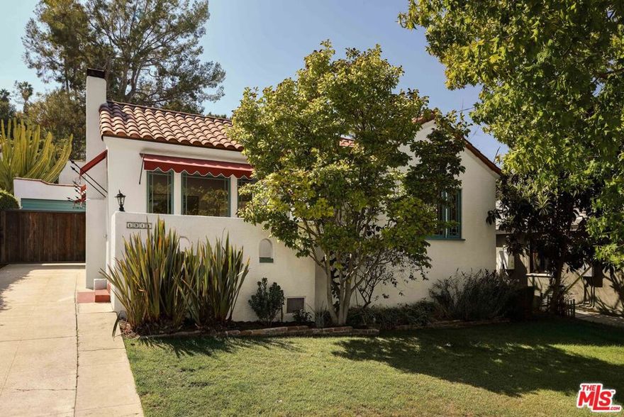 Nestled on a serene street and embraced by lush landscaping and mature trees, this enchanting Adams Hill Spanish invites you to slow down and savor its timeless beauty. A storybook front patio leads into a sun-dappled living room where original windows, coved ceilings, and a terra cotta tile-framed fireplace create a space that feels both soulful and warm. Gleaming wood floors flow throughout, carrying the spirit of the home's history from room to room. A graceful archway opens to the dining room and onward to the kitchen, where daffodil-yellow tile edged in ebony nods to the artistry of its era. Updated appliances provide modern ease, while the charming breakfast nook, wrapped in bay windows, offers a dreamy spot to sip morning coffee, framed by a cascade of fuchsia bougainvillea just outside. Two spacious bedrooms provide a restful retreat, complemented by a full bath adorned with original tile and built-ins that speak to the home's enduring character. Outside, the private backyard unfolds like a hidden garden, with a flat, gated patio surrounded by lush greenery and native plantings; an ideal setting for gatherings and a great place to unwind. Detached garage with long driveway completes the property. Set in the beloved College Streets of Adams Hill, this rare offering is perfectly sited near all the best local hot spots such as Little Ripper, Capri, Dunsmoore, as well as local neighborhood favorites like Kafn Coffee, the beloved Adams Square Mini Park, Palmer Park, Arts Bakery and more. A rare chance to claim a slice of Adams Hill charm where every detail is already in place.