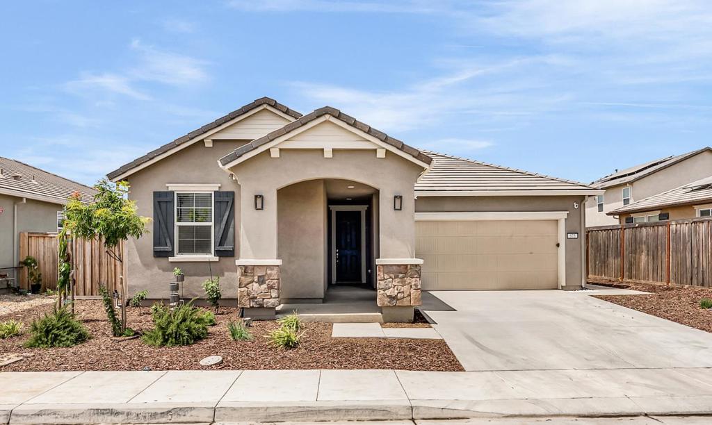 Welcome to Turnleaf at Patterson Ranch! This beautifully maintained single-story home, built just two years ago, features a bright and open-concept layout with soaring 9-foot ceilings that enhance its spacious feel. The thoughtfully designed floorplan includes generously sized bedrooms, walk in closet and bathrooms, providing ultimate comfort throughout. The kitchen is a delight with quartz countertops, ample cabinet space and pantry, a large center island and sink, plus a breakfast bar perfect for casual dining. The home is equipped with energy-efficient upgrades, including a solar energy system, tankless water heater, energy-efficient LED recessed lighting and smart thermostat. Additional highlights include stylish Sterling Oak plank flooring, a dedicated laundry room, and a finished, insulated garage. The newly landscaped backyard offers a covered patio and a smart, water-conserving irrigation system with weather-based controls, perfect for easy, low-maintenance outdoor living. Conveniently located within walking distance of Walnut Grove School (K8) and a brand-new community park, this home combines comfort, efficiency, and modern living in a welcoming neighborhood.
