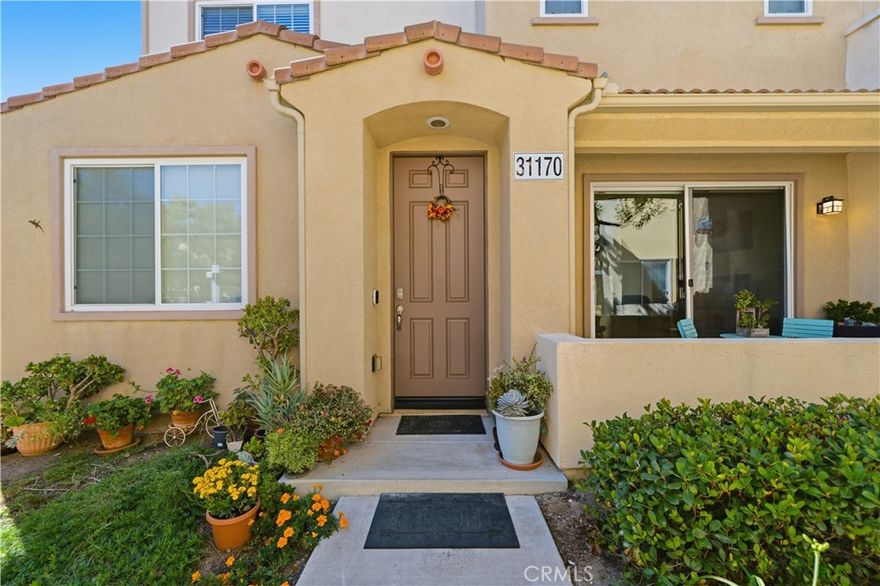 HOME ALSO QUALIFIES FOR A $20,000 GRANT WHICH CAN BE USED FOR A DOWN PAYMENT AND/OR CLOSING COSTS! HIGHLY DESIRABLE 3-BEDROOM CONDO IN TEMECULA LANE’S FAMILY FRIENDLY GATED REFLECTIONS COMMUNITY! Welcome to 31170 Strawberry Lane—offering the best floorplan in the area and nestled in one of South Temecula’s most family-friendly, amenity-rich neighborhoods! This spacious 3-story, 3 bed, 2.5 bath condo boasts a smart and stylish layout perfect for daily family living. The main level opens to a bright and airy grand room with energy-efficient window coverings and flows effortlessly from the dining area and into the kitchen, complete with GE appliances and included refrigerator—ready to host your next gathering! The family room is adjacent for easy entertaining, relaxing, and access to the first floor patio and in-unit laundry with large Whirlpool Dual washer and dryer.  Head upstairs to your private primary retreat featuring a spa-like en suite with a roman tub, separate shower, privacy door, and large walk-in closet. The top floor offers two additional bedrooms, perfect for family, guests, or a home office setup. The home is finished with stone tile, vinyl, and carpet throughout, plus a generous 2-car attached extra large garage with epoxy flooring and With low taxes and a low HOA, enjoy access to resort-style amenities including pool, spa, parks, BBQ areas, playgrounds for kids, and beautiful greenbelts. Located in the award-winning Temecula school district including Great Oak High School and close to shopping, Old Town Temecula, Pechanga Casino, dining, and wine country—this one checks every box!