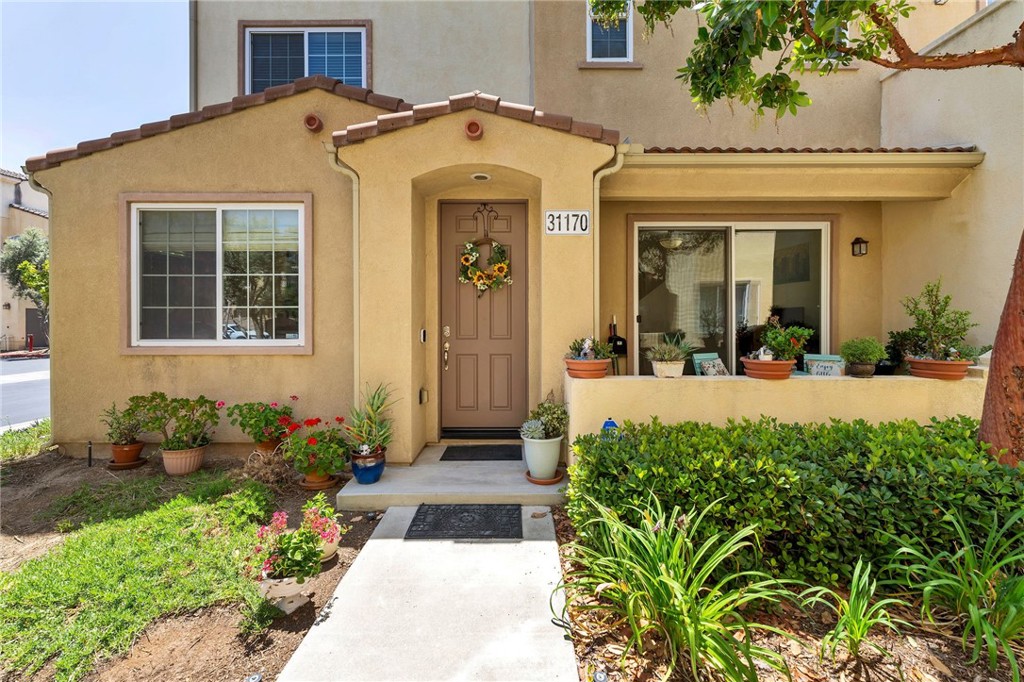 HOME ALSO QUALIFIES FOR A $20,000 GRANT WHICH CAN BE USED FOR A DOWN PAYMENT AND/OR CLOSING COSTS! HIGHLY DESIRABLE 3-BEDROOM CONDO IN TEMECULA LANE’S FAMILY FRIENDLY GATED REFLECTIONS COMMUNITY! Welcome to 31170 Strawberry Lane—offering the best floorplan in the area and nestled in one of South Temecula’s most family-friendly, amenity-rich neighborhoods! This spacious 3-story, 3 bed, 2.5 bath condo boasts a smart and stylish layout perfect for daily family living. The main level opens to a bright and airy grand room with energy-efficient window coverings and flows effortlessly from the dining area and into the kitchen, complete with GE appliances and included refrigerator—ready to host your next gathering! The family room is adjacent for easy entertaining, relaxing, and access to the first floor patio and in-unit laundry with large Whirlpool Dual washer and dryer.  Head upstairs to your private primary retreat featuring a spa-like en suite with a roman tub, separate shower, privacy door, and large walk-in closet. The top floor offers two additional bedrooms, perfect for family, guests, or a home office setup. The home is finished with stone tile, vinyl, and carpet throughout, plus a generous 2-car attached extra large garage with epoxy flooring and With low taxes and a low HOA, enjoy access to resort-style amenities including pool, spa, parks, BBQ areas, playgrounds for kids, and beautiful greenbelts. Located in the award-winning Temecula school district including Great Oak High School and close to shopping, Old Town Temecula, Pechanga Casino, dining, and wine country—this one checks every box!