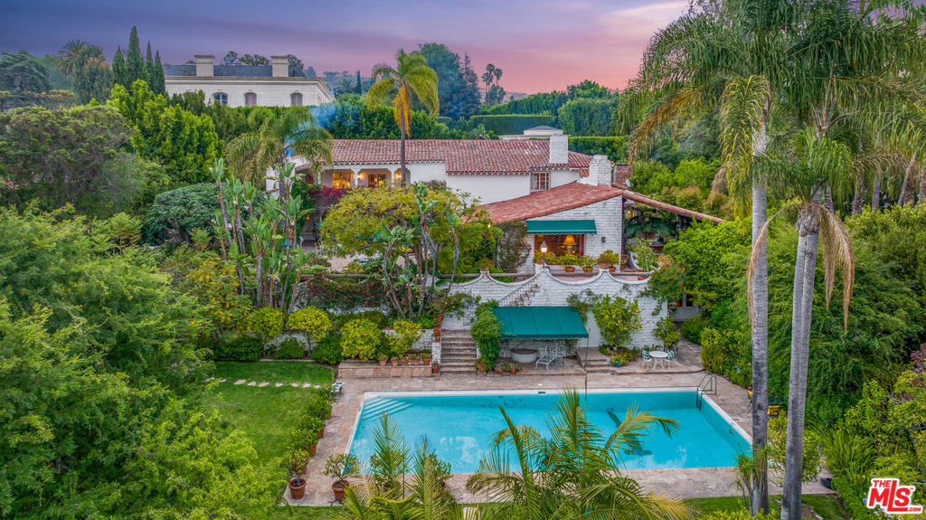MAJOR PRICE REDUCTION!!! Amazing opportunity to renovate, add on or build. Rarely does a lot like this become available. This estate is steeped in history; Kings, presidents, dignitaries, and Hollywood royalty have all been entertained here. Set on just over one acre, this 5 bedroom 8 bath home with 11 wood burning fireplaces is ready for a new owner. The sprawling estate, surrounded by lush greenery, features an elegant private drive, multiple indoor entertaining areas, a massive swimmers pool, vegetable gardens, and expansive outdoor loggias. The grand primary suite features a large walk-in closet, dressing room, and an oversized balcony overlooking the grounds. The lower level, 'Cantina' is an entertainer's dream highlighting one of the many gathering spots throughout the home. Your guests won't want to leave the magical grounds, but instead just stay in the separate casita just a few steps away. This is a once-in-a-lifetime opportunity to own a piece of Los Angeles history, for the most discerning buyer.