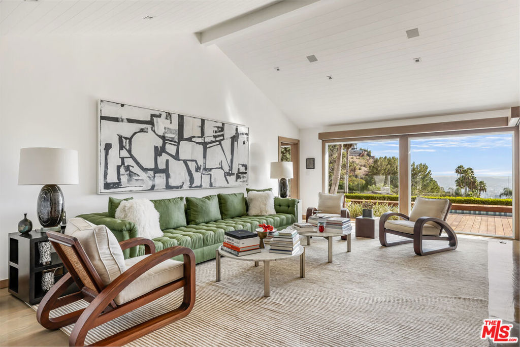 A private oasis in the Bird Streets, this fully renovated, mid-century home is the essence of California cool. With interiors designed by Peter Dunham, the updated ranch house has been published in Elle Decor. After entering the gracious foyer, you are mesmerized by the expansive view from every room. The primary bedroom, living room, family room, dining room, and kitchen all access a recently renovated wood deck and saltwater/mineral pool which evoke a hotel in St Barths. A smart Control 4 system, a standing seam metal roof, Waterworks fixtures, and custom millwork throughout create a polished and updated take on mid-century style. Open to the dining area, the handsome kitchen features Viking and Subzero appliances. A sophisticated primary bedroom suite with pitched ceilings contains a generous walk-in closet and marble bathroom. A library/office tucked into an interior space create the perfect work-from-home setting. Two half baths, a laundry room, two car Garage, and a private second bedroom with en-suite bath complete the floorplan. This pristine, turn-key home on a quiet cul-de-sac offers the best of the Bird Streets and a dazzling view all day and night.