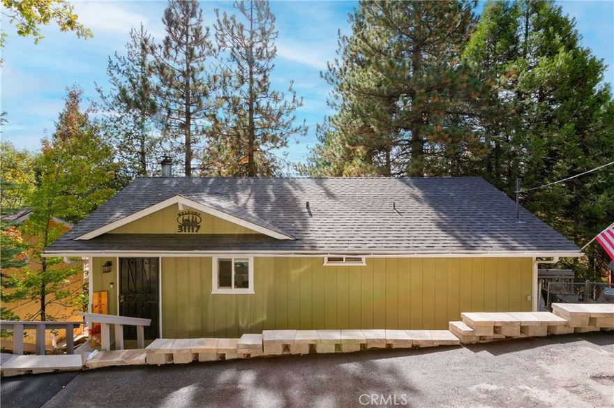 Welcome to this beautifully updated 2-bedroom, 1-bath home nestled among the trees, offering breathtaking views of Mt. San Gorgonio and the surrounding mountain landscape. Step onto the spacious deck and soak in the serene beauty. Inside, you’ll find a warm and inviting space featuring tongue-and-groove ceilings, knotty Alder doors, new light fixtures, and dual-pane windows with new blinds that fill each room with natural light. The kitchen boasts new countertops, adding a fresh touch to this cozy mountain retreat. Practical updates give you peace of mind, including a 3-year-old roof, 2-year-old driveway and retaining walls, and a fenced backyard ideal for pets or outdoor relaxation. Additional highlights include a plug-in for a generator, large storage area. Whether you’re looking for a full-time residence or a weekend getaway, this home offers the perfect blend of comfort, character, and nature.