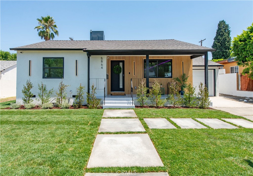 Welcome to 5864 Jamieson Ave, a stunning 3-bedroom, 3-bathroom home that has been reimagined & expanded to 1,993 sqft. Step onto the inviting front porch where modern design meets natural warmth. Vertical wood slat siding paired w/ sleek black accents creates eye-catching curb appeal, while elegant lighting adds a touch of sophistication. Inside, the oversized living room provides ample space for both relaxation & entertainment. Ambient LED lighting lets you set the perfect mood. At the heart of the home is a showstopping modern kitchen featuring an oversized marble waterfall island w/ seating for four—ideal for entertaining or casual meals. Two-tone cabinetry combines glossy white uppers & warm wood lowers for a clean, contemporary look. Stainless steel appliances, including a gas range & built-in hood, are seamlessly integrated. Striking pendant lights, recessed lighting, & natural window light keep the space bright & open. Adjacent, the elegant dining area features a custom vertical slat accent wall in a soft neutral tone, adding architectural interest. A hidden pantry offers sleek storage beyond the already generous cabinetry. Light wood floors flow throughout, complemented by recessed lighting & large sliding glass doors that open to the outdoor space, filling the home w/ natural light. The primary suite is a private retreat with its own spa-like bathroom, walk-in closet, & direct access to the deck & pool. The bathroom features a floating dual vanity with natural wood cabinetry, marble countertops, & LED mirrors. An oversized walk-in shower with a frameless glass enclosure & rainfall showerhead pairs beautifully with a freestanding soaking tub beneath a recessed accent shelf with ambient lighting. Matte black fixtures & large-format tile flooring complete the look.
A spacious secondary bedroom & designer bath sit tucked into their own private wing. On the opposite side of the home, a secondary suite offers ideal guest accommodations, w/ its own access to the deck via sliding glass doors. The stylish en-suite includes a large shower, designer vanity, & LED mirror. Outside, an expansive deck offers space to relax & entertain beside the sparkling pool. A generous grassy area is perfect for play, with a large shed to keep things tucked away. Upgrades include fingerprint door access, wood slat accents, LED lighting, new roof, new AC, fully remodeled interior & exterior, laundry room for side-by-side units, direct garage access, Ecobee thermostat & more.