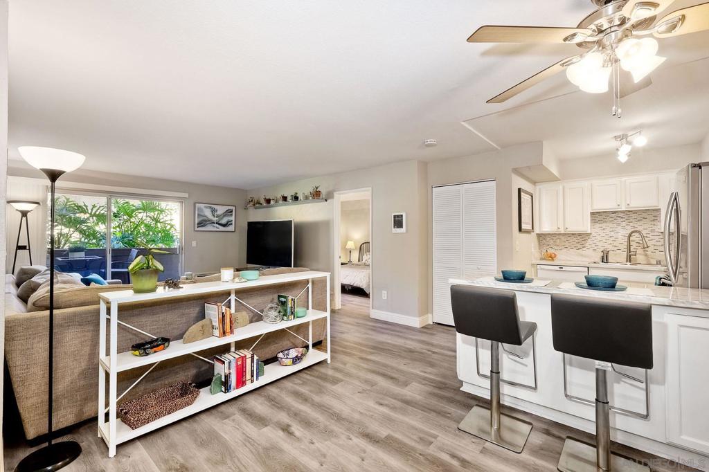 Gorgeous 2 Bed, 2 Bath Condo w/ a prime location near SDSU! This beautifully upgraded home is perfectly situated on the first floor for effortless, stair-free living & has 1 assigned parking space. The open floor plan was designed for privacy w/ bedrooms & baths on opposite sides making this an excellent setup for roommates, guests or a peaceful home office/retreat. Enjoy designer wall colors, luxury vinyl & tile flooring and a sleek kitchen featuring white cabinetry, quartz counters, SS appliances and a breakfast bar peninsula. The spacious living room opens to a relaxing patio surrounded by lush landscaping. The primary suite includes tall windows, dual closets and linen cabinets. The second bedroom also has tall windows and a walk-in closet. Both bathrooms are tastefully upgraded with modern finishes. Community amenities include a pool, rec room, BBQ area, plus water and trash service. Just steps from SDSU, hospital, restaurants, shops, trolley & Lake Murray - Be at the heart of San Diego living!