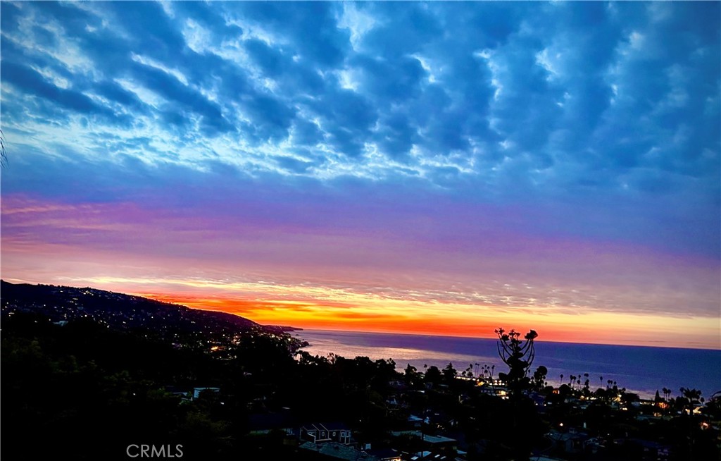 Nestled within the exclusive gated community of Allview Terrace in coveted North Laguna, this stunning home boasts breathtaking vistas of the coastline and city lights. Located near beach, town, shopping, hiking and biking trails, Heisler Park and Riddle Field with the convenience of easy access out of Laguna without tangling with the downtown traffic. Step inside to discover a chef's kitchen seamlessly flowing into a spacious great room, all overlooking the lush backyard oasis featuring a glistening saltwater pool. The luxurious primary suite, located on the main floor, indulges in sweeping panoramic views, while its spa-like bath invites relaxation with a generous walk-in shower and elegant soaking tub, opening to a secluded secret garden. Also on the main level is a guest room with an adjacent bath for added comfort and convenience. Descend to the lower level, where privacy reigns supreme, presenting a sizable great room complete with an additional kitchen. Here, a third bedroom suite and bath await, all opening onto an inviting outdoor loggia with direct access to the pool, perfect for entertaining or unwinding in style. An alcove, versatile as a fourth bedroom or office space, adds further flexibility to this meticulously appointed residence. Recently refurbished with new kitchen amenities, updated bathroom, refreshed flooring, every corner radiates with modern elegance and comfort. For those seeking a temporary sanctuary or a longer-term retreat, this home offers the flexibility of a short-term furnished lease of at least 31 days, with the possibility of considering long-term arrangements. Indulge in coastal luxury living at its finest – submit your offer and make this extraordinary property your home.