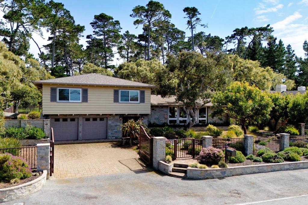 Nestled in the heart of the prestigious Pebble Beach community, this beautifully updated 4-bedroom, 3-bathroom home offers a perfect blend of modern amenities and coastal charm. Remodeled in 2013 and spanning 2,600 square feet, this expansive residence features an open floor plan that seamlessly connects the living, dining, and kitchen areas, creating an inviting space ideal for both everyday living and entertaining. The spacious patio is a standout feature, equipped with a cozy fireplace and a soothing hot tub, providing the perfect setting to unwind and enjoy the serene surroundings. A short walk to the ocean allows for easy access to the beautiful coastline, where you can indulge in the sights and sounds of the Pacific. The property also offers modern conveniences such as a backup generator and an electric security gate for enhanced privacy and security. This exceptional Pebble Beach home provides the ultimate coastal living experience with style, comfort, and convenience at every turn.