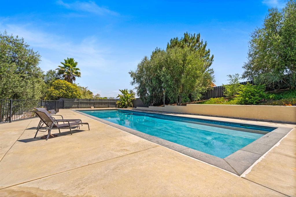 Welcome to 23839 Vista Ramona Rd, a beautifully maintained 4-bedroom, 2.5-bathroom home nestled in the heart of the highly sought-after San Diego Country Estates in Ramona, CA This spacious 2,498 sq ft home sits on a desirable corner lot, offering privacy, panoramic mountain views, and a truly serene setting surrounded by lush trees and meticulous landscaping. Step into comfort and efficiency with owned solar, keeping energy costs low year-round. Enjoy sunny Southern California days in your sparkling 60 ft x 20 ft pool—perfect for relaxing, entertaining, or swimming laps. The property also features a spacious 3-car garage, offering ample storage and convenience. Inside, you’ll find an open and inviting floor plan with tile flooring throughout, generous living spaces, natural light, and a seamless connection to the scenic outdoors. Whether you’re enjoying your morning coffee with breathtaking views or hosting guests in your private backyard retreat, this home provides the perfect balance of indoor-outdoor living. Located in a peaceful community known for its natural beauty, hiking trails, golf course, equestrian centers and family-friendly amenities, this property is a true gem. Don’t miss this rare opportunity to own a slice of paradise in San Diego Country Estates. Schedule your private showing today!