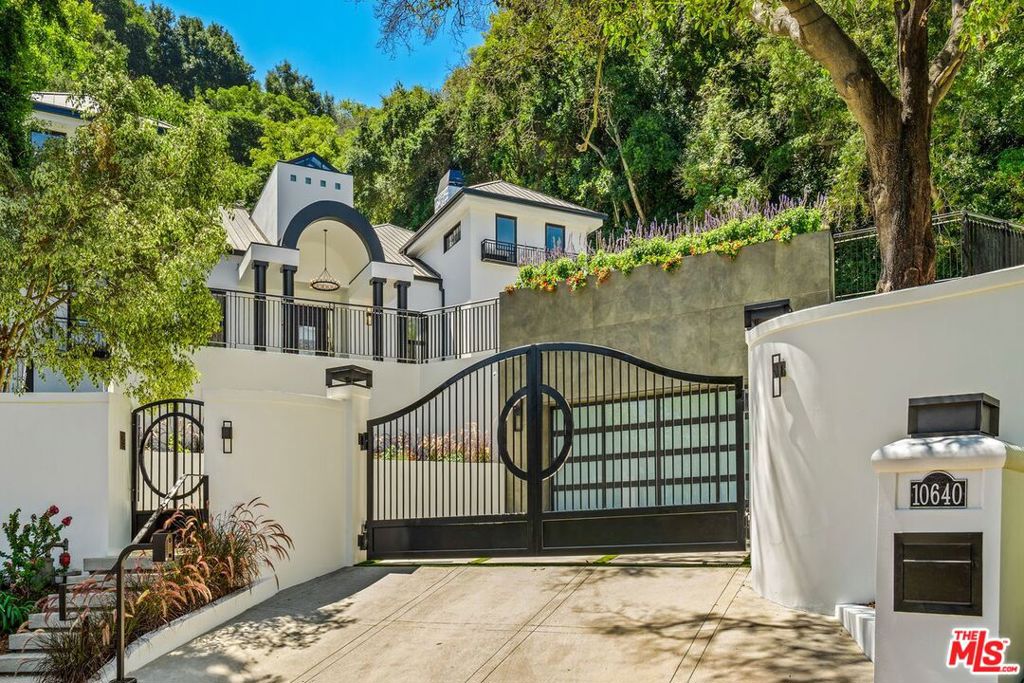 Nestled in the prestigious and tranquil enclave of Stone Canyon in Bel Air, this exquisite gated estate masterfully blends modern sophistication with timeless traditional elegance. Set at the end of a peaceful cul-de-sac, the property spans over an acre of lush grounds, adorned with mature trees and meticulously landscaped gardens, providing a serene and private retreat from the bustling city life.As you approach, the grand motor court, accentuated by a stylish sitting area and vibrant planters, welcomes you to the estate, hinting at the luxurious experience within. The dramatic two-story entryway is nothing short of breathtaking, featuring an atrium-style ceiling with expansive glass windows that flood the space with natural light, creating a warm and inviting ambiance.The interior showcases an impeccable renovation, highlighted by the rich beauty of hardwood floors that flow seamlessly throughout the home. The main floor boasts a gorgeous office library, perfect for working from home or enjoying a quiet read, surrounded by custom woodwork and elegant finishes that enhance the sophisticated atmosphere. Additionally, a sumptuous guest suite on the first floor offers comfort and privacy, making it ideal for hosting visitors or accommodating family members.The formal living room, complete with a stately fireplace and an intimate sitting area, offers the perfect space for relaxation or entertaining, while the adjacent formal dining room, equipped with a wet bar and framed by large windows, invites you to indulge in fine dining with verdant views of the surrounding greenery.For more casual gatherings, the estate boasts an incredible family room that opens up to the picturesque backyard through sleek sliding doors. This space is perfectly complemented by a gourmet kitchen, where a magnificent center island takes center stage, surrounded by top-of-the-line appliances and elegant finishes. The dining area, bathed in natural light, is ideal for everyday meals, while the outdoor barbecue area and sparkling pool offer endless possibilities for alfresco dining and summer soirees.The upper level, accessed via a stunning spiral staircase, houses four beautifully appointed bedrooms. The primary suite is a sanctuary of luxury, with its soaring ceilings, serene views, and two expansive walk-in closets. The en-suite bathroom is a masterpiece, featuring exquisite finishes and ample space for relaxation. Additionally, the upper floor includes three additional guest bedrooms, each offering comfort and privacy, as well as a versatile lounge, study room, or play area to suit your family's needs.The lower level of this magnificent home is designed for ultimate convenience and leisure. A wonderful gym and massage room, complete with a private bathroom, cater to your wellness needs, while the rare 10-car garage provides ample space for your prized automobile collection.This estate is more than just a home; it is a lifestyle. Every detail has been thoughtfully curated to provide an unparalleled living experience in one of Bel Air's most coveted locations. *Please note that the garage photo has been virtually staged for illustrative purposes. The vehicles shown in the image are not included in the sale of the property.