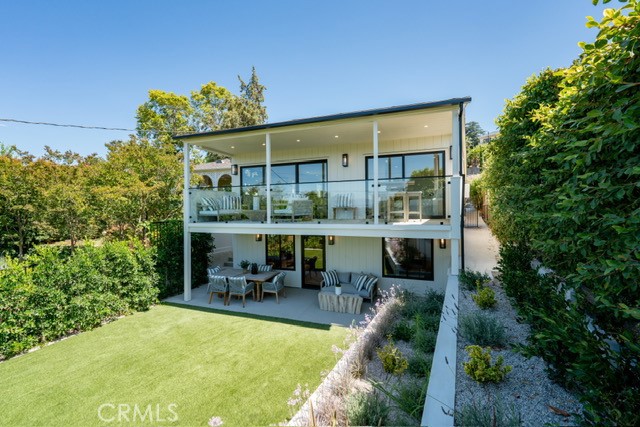 New!!!! Experience elevated living in this beautifully reimagined custom home, ideally located South of the Boulevard in one of Sherman Oaks’ most coveted neighborhoods—walking distance to Ventura Blvd’s top restaurants, boutiques, and cafes. Meticulously remodeled with a focus on natural, organic design, this light-filled sanctuary features an airy open floor plan with vaulted white oak ceilings, expansive sliding glass doors, and serene tree-dappled views. The chef’s kitchen is a showstopper, showcasing Taj Mahal natural stone countertops, Thermador appliances, custom white oak cabinetry, and European white oak floors throughout. Indoor-outdoor flow is seamless, opening to perched balcony and a lush backyard with a covered patio—ideal for entertaining or quiet relaxation with room for an infinity pool to complete the outdoor oasis. A rare blend of high-end craftsmanship, tranquility, and walkability in prime Sherman Oaks.