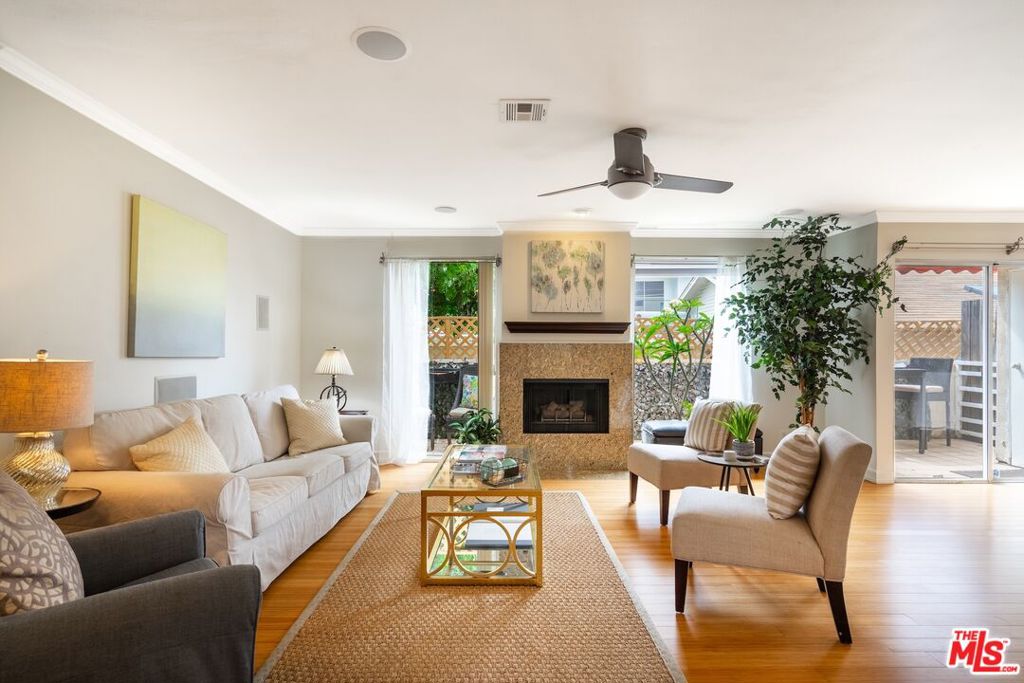 Contemporary Coastal Townhome in Santa Monca! Tri-Level 3 Bedrooms + 3 Baths with 1803 sqft in an intimate Community of Four Townhomes. Unique double loft provides adaptable space for home office and gym. Bright and light-filled unit with numerous skylights and glass block walls with seamless bamboo flooring extends throughout the residence. Spacious living areawith decorative fireplace and floor to ceiling windows. Stylish wet bar with granite countertops and lots of cabinets and a wine fridge, living room has integrated ceiling speakers. Chefs Kitchen with granite counters and stainless steel appliances with convenient breakfast bar and extensive cupboard space. Dining room opens to your own private patio, Inside laundry and central heat and ac. Generous size secondary bedrooms. Primary suite with vaulted ceilingsand walk-in closet and primary bath with dual sinks. Low homeowners dues include water. Large private storage in lower level with a Direct access to a 2-car side by side parking. Located in the Santa Monica School District. Experience the best of Santa Monica with Whole Foods, Trader Jo's, Erewhon, Bristol Farms and countless shops, restaurants and services all within easy reach