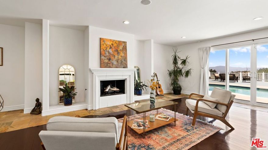 An artist's haven, this single-level Mediterranean gem has housed entertainment professionals from writers and actors to painters and songbirds, all of whom have derived inspiration from the hilltop valley views and surrounding mountain scapes. Aptly named after famed Edgar Rice Burroughs', Tarzan of The Apes, the hills of Tarzana are among the 550 acres of goat ranch once owned by Mr. Burroughs himself, purchased by the profits of his fantasy character/the fictitious Lord of the Jungle. Showcasing inescapable views of the San Fernando Valley, the Santa Monica Mountains, and the San Gabriel Mountain Range, this eclectic family home offers an escape from the hustle and bustle of city life, while conveniently located 25 miles from downtown Los Angeles. Proudly owned for more than 30 years, this property was extensively renovated in 2001 by the homeowners and has been recently enhanced with fresh interior and exterior paint, newer refrigerator and washer/dryer, tankless water heater, gas range, fireplace, windows, ceiling fans/lights, plumbing fixtures, backyard turf/lounge area, front landscape, solar landscape lights, solar motion detector lights, HVAC unit, and renovated primary bath/shower. Fruit trees surround the property including a Pomegranate tree, Fig tree, Loquat tree, Orange Tree, and Lemon/Citrus tree. Located within the Los Angeles Unified School District, this tranquil home is in close proximity to top-rated schools, hiking and biking trails, luxury markets, palatable farm-to-table dining, and is just 20 miles to the beach. LEASE OFFERED | 12-months minimum ~ Tenant to obtain renter's insurance policy ~ RentSpree application required with $39.99 application fee. All tenants over the age of 18 must complete an application and be a party to the lease agreement.