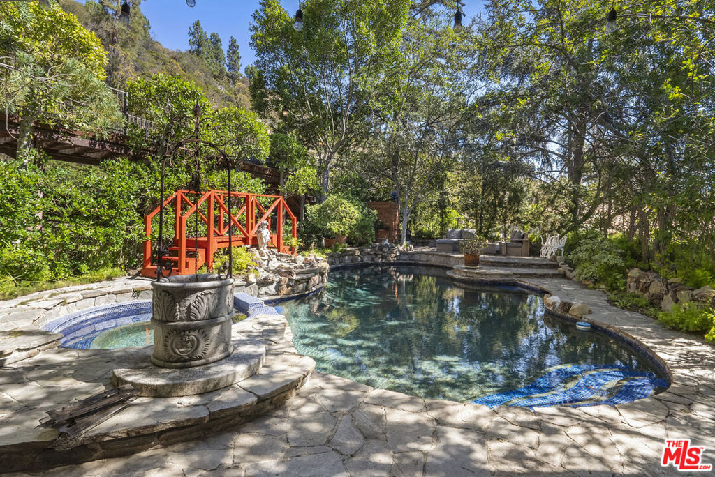 Tucked high in the coveted Hollywood Hills, this sophisticated retreat offers a seamless blend of California cool and timeless elegance. Surrounded by lush greenery, the home feels like a private sanctuary- yet its just moments from the famous Sunset Strip. The layout is both refined and functional: three spacious bedrooms, inviting living and dining areas, and spacious family room off of the Kitchen. Move-in ready! This home offers the rare balance of privacy, style, and city access.