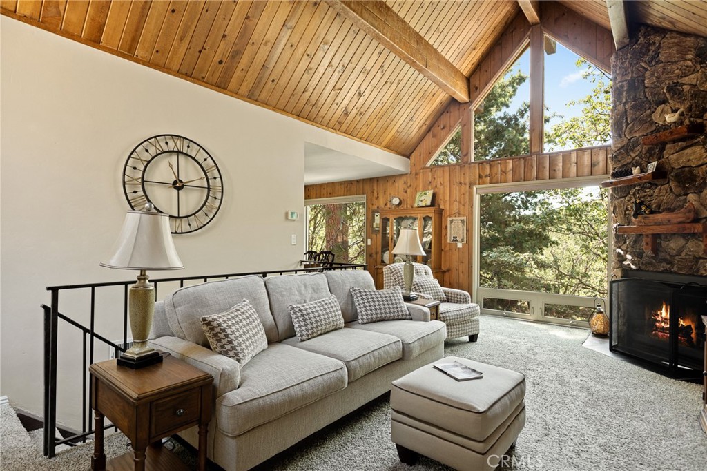 Tucked into a peaceful pocket of Lake Arrowhead where the streets are wider and the pace slows to mountain time, this residence embodies the timeless appeal of a Thunderbird floorplan, enriched with thoughtful upgrades and framed by nature’s quiet beauty.
Fresh exterior paint and a newly paved driveway set the stage with polished curb appeal and effortless arrival. Step inside, where soaring T&G wood ceilings draw the eye upward and expansive picture windows unveil sweeping ridgeline views, filling the home with soft, golden mountain light.
This sought-after layout beautifully balances connected spaces and private retreats. The main living area, anchored by a dramatic stone fireplace, invites laughter, lingering conversations, and evenings warmed by its glow. Just beyond, the dining area opens to panoramic forest vistas, making every meal feel elevated by the view.
The large kitchen makes hosting effortless, while the den with its own fireplace downstairs introduces a cozy second living space perfect for movie nights, board games, or a quiet retreat.
Comfort and functionality are thoughtfully arranged: three spacious bedrooms and two full baths, each enjoying tranquil tree-top views, yet just minutes from Lake Arrowhead Village. Recent upgrades including an upgraded heating system and double-pane windows ensure comfort, efficiency, and peace of mind in every season.
Enhancing its allure, the home includes Lake Arrowhead lake rights, offering access to private beaches, community docks, and the full tapestry of lake life.
Here, every detail from wider, more accessible roads to the tranquil setting works in harmony to create a lifestyle defined by peace, natural beauty, and connection. Whether as a full-time haven, a weekend retreat, or a gathering place for family and friends, this Walnut Hills residence invites you to make Lake Arrowhead your story.