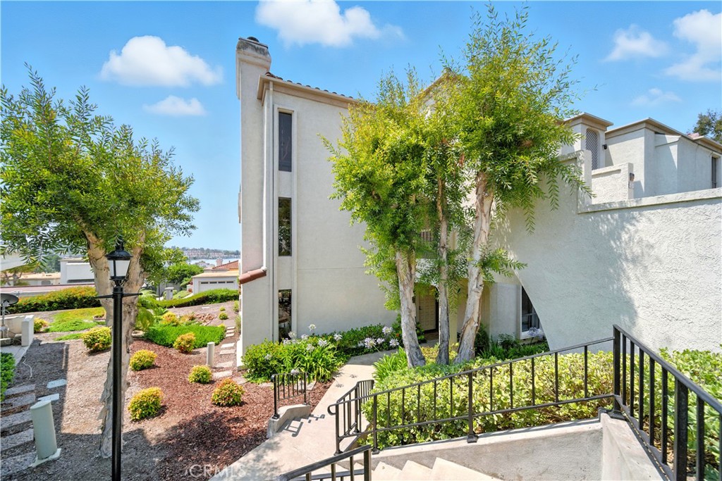 Welcome to 27762 Arta, a serene garden-level condo in the exclusive gated community of Mallorca on Lake Mission Viejo! This beautifully updated home offers the perfect blend of style, privacy, and breathtaking views. Completely remodeled, this 2-bedroom, 2-bath condo boasts laminate plank flooring in the main living areas, stylish tile in the kitchen and baths, and no carpet throughout. Enjoy expansive mountain views, spectacular sunsets, and peek-a-boo lake views—all from your spacious patio that feels like a private backyard. The rear wall of glass brings in natural light and stunning vistas, while the orientation keeps the unit cool, minimizing the need for air conditioning. Inside, you’ll find contemporary upgrades throughout, including modern doors, cabinetry, countertops, roller shades, lighting, and fixtures. Both bathrooms feature sleek, current tile work and finishes. Cozy up by the gas fireplace in the winter, or entertain guests year-round—this unit has hosted large gatherings thanks to its unique outdoor space. This is a true turnkey opportunity.
Not to be overlooked are the incredible amenities that define the Mallorca lifestyle. This private, resort-style community features a 24/7 manned gate for added peace of mind and security. Residents enjoy exclusive access to the Mallorca private beach, complete with a sandy shoreline, a designated swim area, 14 shaded picnic tables, 4 BBQ stations, lounge chairs, a cabana, restrooms and a convenient outdoor shower area to rinse off after a day in the sun. For boating enthusiasts, the community offers 72 in-water boat docks and additional dry docks for paddleboard storage. Take a stroll along the lakeside promenade, where vibrant views and the soothing sounds of the water create a tranquil, scenic walking path. For more traditional relaxation, Mallorca boasts two pool and spa areas, perfect for unwinding or spending time with friends and family.
Lake Mission Viejo is also a true highlight. As a lake member, you’ll enjoy access to year-round boating and swimming, summer concerts and movies under the stars, a spectacular fireworks show, beach volleyball, the popular “Taste of the Lake” picnic, and access to lakefront clubhouses for events and gatherings.
Mallorca isn’t just a place to live—it’s a lifestyle. Don’t miss this rare opportunity to own one of the most private, updated units in Mallorca!