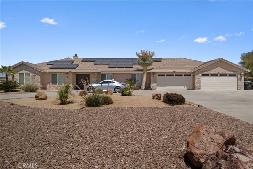 Large and beautiful home for sale in Oak Hills. If you are looking

for a larger home with 5 bedrooms and 3 bathrooms, this is it. When

you arrive at this house, the large cement circular driveway greets

you along the extended cement pad for up to 6 additional parking

spots. The desert landscape compliments perfectly the modern and

low-maintenance yard. Tile floors throughout the house provide a

distinctive look and a clean feeling. This home has two fireplaces and

several walk-in closets. The fully fenced pool is ready for your

enjoyment and comes with a hot tub that cascades into the pool.

Decorative boulders compliment the fire pit near the pool. A pool

house allows for the convenient enjoyment of being outdoors. This

house has 2+ acres of land with gates and mostly block walls. This

lovely home comes with a double electric oven, a gas stove, and a

stainless steel fridge. The ample kitchen can be a delight for the chef of

the house. Granite countertops and a large island provide convenience

for preparing meals for everyone to enjoy. You will discover that the

split floor plan is super convenient due to having 3 bedrooms and 2

baths on one side of the house and 2 bedrooms and a full bath on the

other side. There are 3 access doors to the back yard. The roomy

covered patio adds to the many possibilities. This home has a fully

owned solar system with newer backup batteries. Make sure you come

view this home and notice the value of living here.