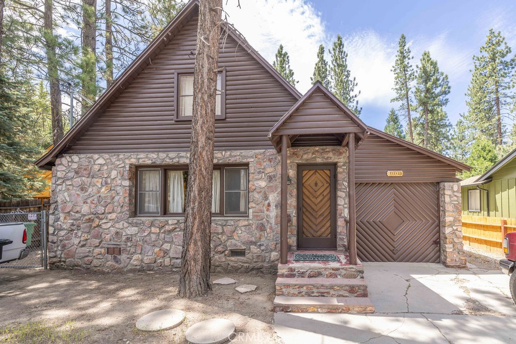 This cute, rustic 3 bedroom, 2 & 3/4 bath cabin is located a few blocks from Mountain Transit Trolley
stop, sledding, dining, & convention center events, as well as a short drive to skiing, shopping, & the
lake! Take in the well-treed front yard from the big picture window in the living room. This home
features lots of native rock inside and out, including 2 large native rock fireplaces; one in the living
room, & one in the den, as well as native rock siding and new paint outside. Both chimneys have been
recently swept, and the roof is a newer 30-year composition roof. Additionally, the seller added a new
200-amp sub panel. The many windows make the home feel bright & airy, tempered with woodsy
charm from the T&G walls & open beam T&G ceiling in the living room & master bedroom, as well as
knotty pine cabinets in the kitchen, wood beam wainscoting in the hallway to one bedroom, & the solid
wood shutters in the family room. With lots of sleeping space, & a large, fenced backyard with room to
add on or build an ADU, the layout could accommodate large families or visiting groups. Plus, there’s a
1 car garage & 2 swing-gate set up for extra parking. This sweet vintage cabin has lots of potential as
a mountain getaway, vacation rental, investment, or full-time home.