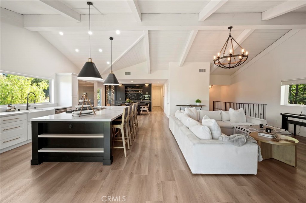 A rare opportunity to own a truly special street-to-street single-family home with a pool, spa, and sweeping views—nestled in the heart of Calabasas. Located in one of Southern California’s most coveted and prestigious zip codes, this unique property offers a harmonious blend of privacy, natural beauty, and endless potential. The main floor is open-concept drenched in natural light, where expansive windows frame treetop views and create a warm, modern treehouse ambiance. The seamless flow between the kitchen, dining, and living spaces sets the stage for elegant entertaining, peaceful relaxation, and unforgettable moments with loved ones. Sophisticated yet inviting, the interiors are thoughtfully designed with a balance of modern style and cozy comfort. The spacious primary suite feels like a private retreat, complete with a custom walk-in closet, steam shower, and built-ins that enhance both function and design. Outside, the resort-style grounds are an entertainer’s dream—complete with a sparkling pool (a rarity in the Highlands), spa, water features, large deck, surround sound, and an outdoor kitchen with built-in BBQ and dining areas. Mature trees and canyon views create a tranquil setting for enjoying the best of California living. A detached one-bedroom, one-bath guest house with its own private entrance offers the perfect space for visitors, extended family, or even rental income. Additional features include gated parking along with driveway parking, a two car garage with storage space, solar panels for energy efficiency, and a unique layout that spans from street to street for added convenience and privacy. All this, just minutes from the Commons at Calabasas, the 101 freeway, and the exclusive communities of Hidden Hills and Malibu.