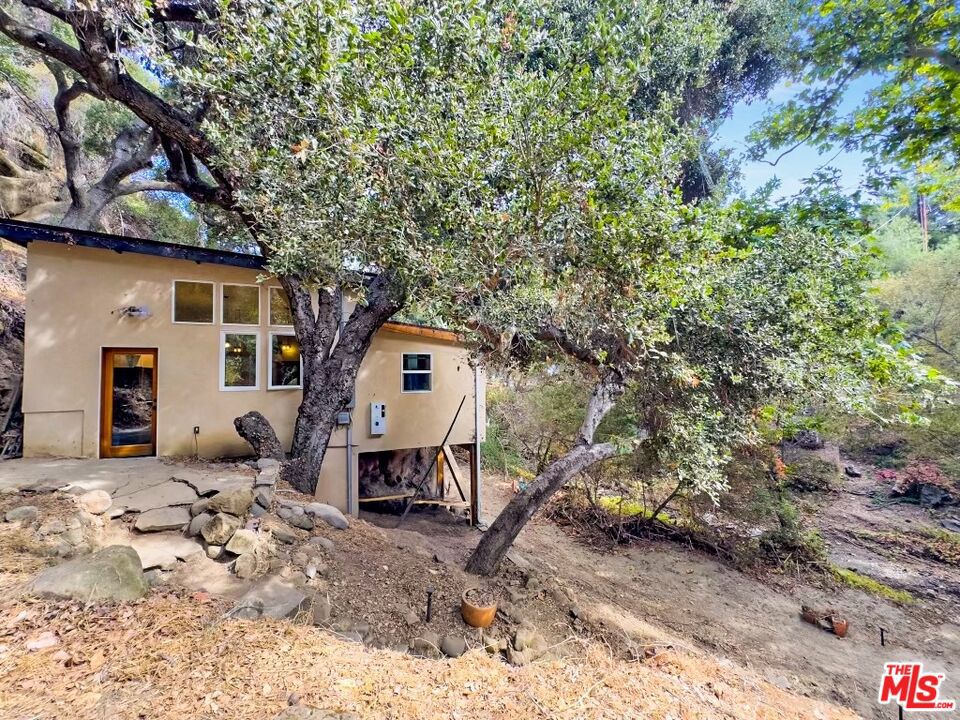 A Topanga Gem Historic, Reimagined, and Set on Nearly Half an Acre. Discover a rare opportunity to own a piece of Topanga Canyon's creative history! This unique, one-bedroom creekside cottage, fully rebuilt and permitted as of 2016, rests on three combined lots totaling 0.49 acres of natural Topanga terrain. Nestled in a peaceful, artistic community, this property captures the essence of Topanga's charm and offers a perfect blend of vintage character and modern upgrades. Lovingly restored by renowned local architect Cary Gepner, this cottage brings together impeccable craftsmanship and respectful preservation of history. Built on an updated solid foundation with 8 x 8 beams, the home features abundant natural light and is exceptionally well insulated for comfort year-round. Gepner, known in Topanga for his dedication to harmonizing architecture with nature, breathed new life into this once-decaying property. Together with the current owner, who was determined to preserve and improve this artistic haven that many deemed impossible to save, they transformed this humble, 840-square-foot home into a cozy, inviting space that still holds the spirit of its past. Adding to its allure, a 4-cable suspension bridge on the property awaits restoration, offering a unique project for the discerning buyer. The cottage's legacy began with Hollywood special effects artist Paul Blaisdell and his wife, Jackie, who lived here from 1953 to 2006. Blaisdell made waves in the 1950s with his imaginative monster costumes for iconic B-movies like "The Beast with a Million Eyes" and "It Conquered the World." His creations, made on minimal budgets but with boundless creativity, became staples of sci-fi and horror cinema. The cottage served as his creative retreat, where he dreamed up monsters that would go down in film history. After Paul's passing in 1983, Jackie continued to keep his legacy alive, sharing stories of their life here with fans of his work. With nearly half an acre of private land, there's plenty of space to garden, relax, or simply enjoy the surrounding nature. Whether you're drawn by the history, the artistic vibe, or the natural beauty, this property promises a lifestyle that celebrates creativity, resilience, and Topanga's unique charm. Located in an artistic community and surrounded by natural greenery, it offers a peaceful setting ideal for relaxation and inspiration. Listing includes additional APN#'s 4444-024-002 & 4444-023-013