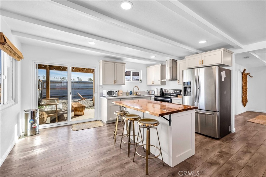WELCOME TO YOUR DESERT RETREAT IN LANDERS! Experience serenity and style in this beautifully remodeled 2-bedroom, 1-bathroom home, set on 2.5 acres of breathtaking desert landscape. Whether you're looking for a full-time residence, a weekend escape, or a lucrative Airbnb investment, this fully furnished, move-in-ready oasis is the perfect fit! All appliances are included, and this property has been a profitable Airbnb for many years. Completely updated within the last four years, the home features recently upgraded flooring, sleek kitchen cabinets and countertops, fresh stucco, and interior/exterior paint. Stay comfortable year-round with updated mini-splits and ceiling fans in every room. Plus, a new 200-amp electrical panel ensures modern efficiency. Step outside into your fully fenced backyard, a private retreat designed for relaxation and entertainment. Soak in the spa, gather around the cozy fire pit, and unwind under the covered patio while taking in stunning sunsets and star-filled desert skies. With expansive desert and mountain views, this peaceful retreat seamlessly blends modern comfort with the beauty of nature. Don’t miss out on this Landers gem—schedule your showing today!