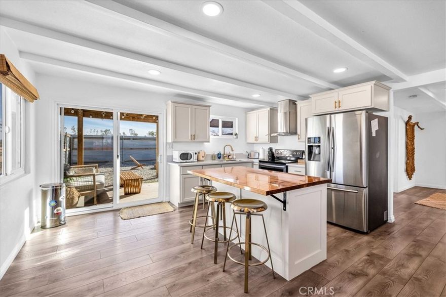 WELCOME TO YOUR DESERT RETREAT IN LANDERS! Experience serenity and style in this beautifully remodeled 2-bedroom, 1-bathroom home, set on 2.5 acres of breathtaking desert landscape. Whether you're looking for a full-time residence, a weekend escape, or a lucrative Airbnb investment, this fully furnished, move-in-ready oasis is the perfect fit! All appliances are included, and this property has been a profitable Airbnb for many years. Completely updated within the last four years, the home features recently upgraded flooring, sleek kitchen cabinets and countertops, fresh stucco, and interior/exterior paint. Stay comfortable year-round with updated mini-splits and ceiling fans in every room. Plus, a new 200-amp electrical panel ensures modern efficiency. Step outside into your fully fenced backyard, a private retreat designed for relaxation and entertainment. Soak in the spa, gather around the cozy fire pit, and unwind under the covered patio while taking in stunning sunsets and star-filled desert skies. With expansive desert and mountain views, this peaceful retreat seamlessly blends modern comfort with the beauty of nature. Don’t miss out on this Landers gem—schedule your showing today!